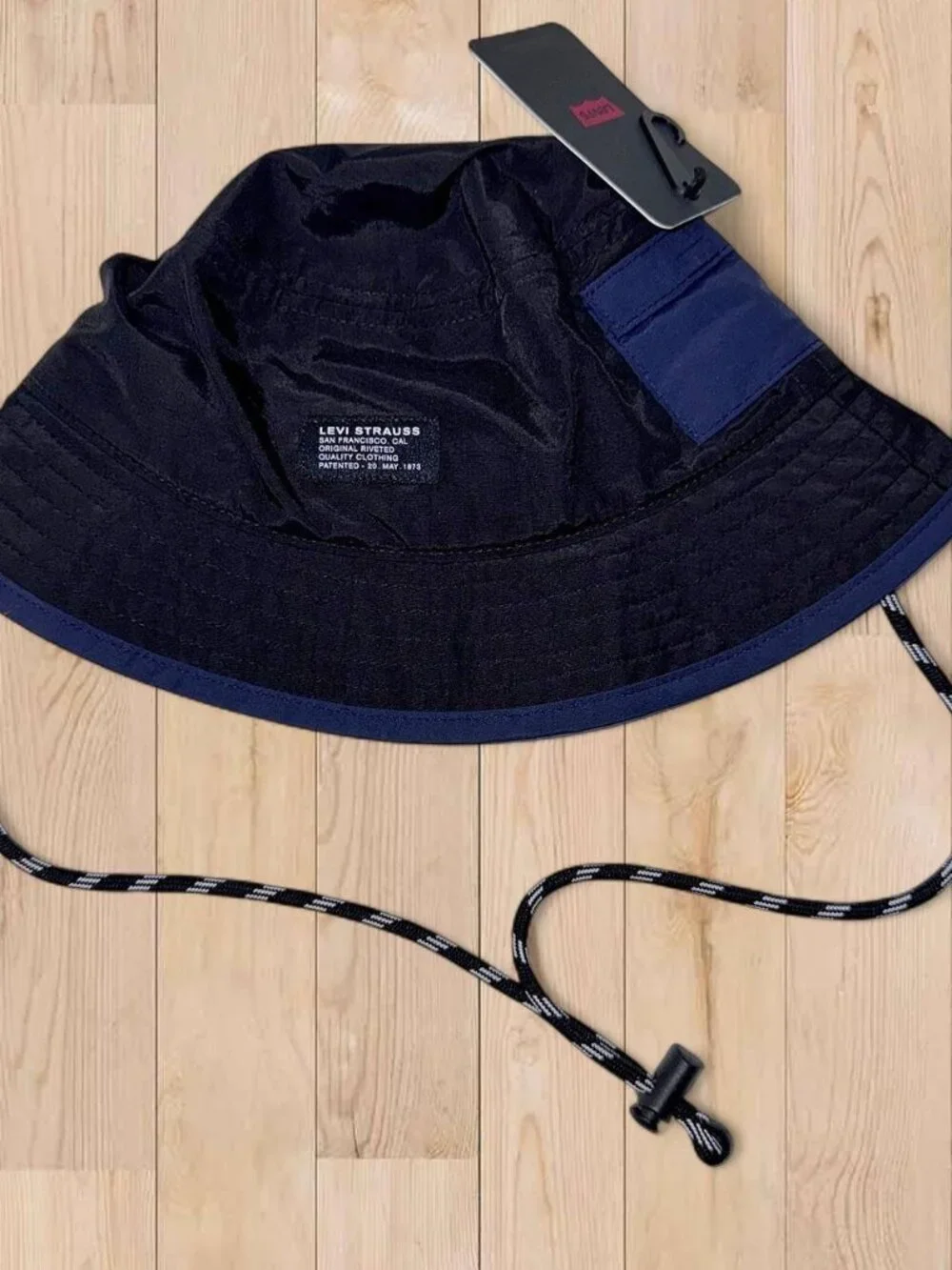 Levi's black bucket hat with adjustable chin strap and utility pocket